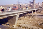 Vista de un lateral del puente con gente y vehculos sobre el puente "B"